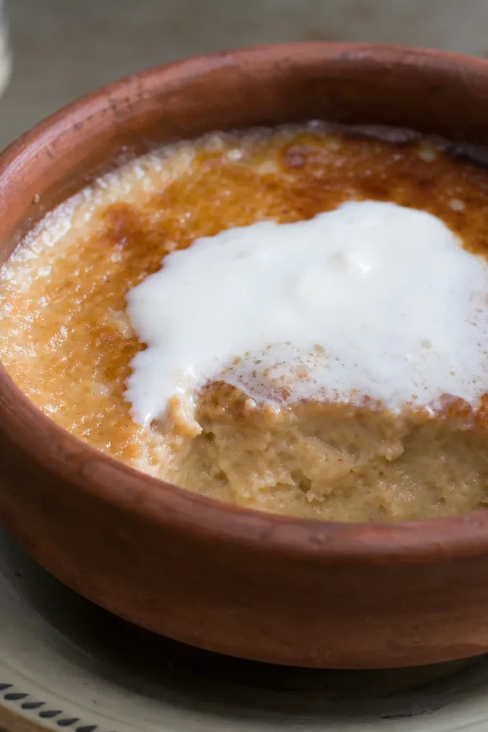 Creamy Mishti Doi topped with caramel, served in a decorative bowl with a smooth texture.