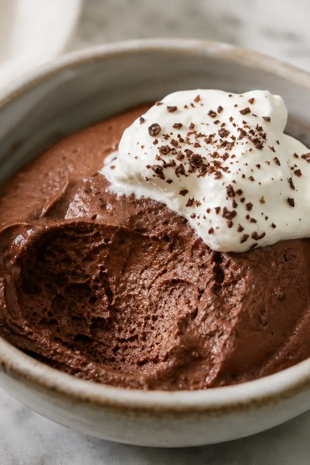Smooth and velvety Belgian chocolate mousse topped with dark chocolate shavings and served in elegant glasses.