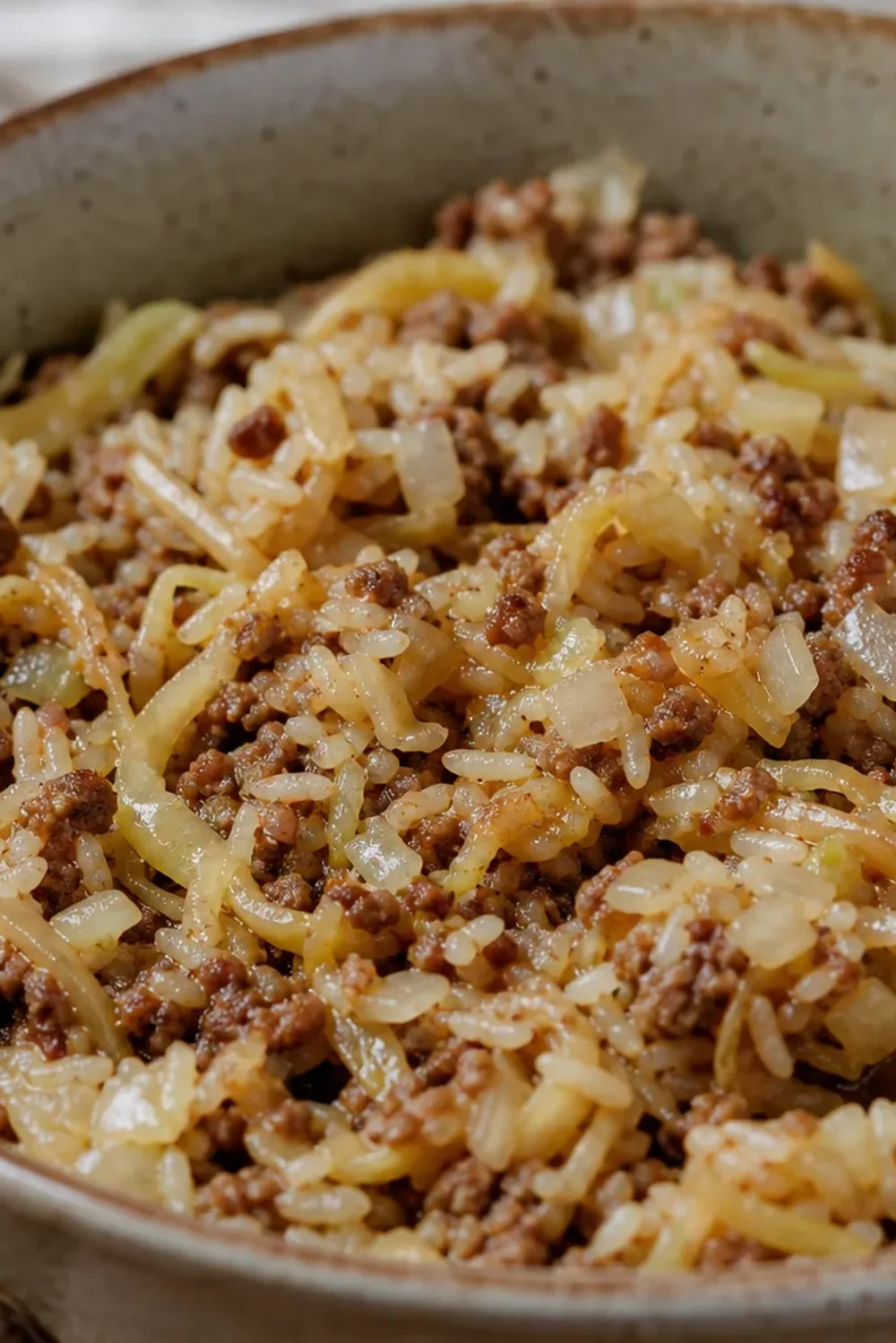 Layered Finnish cabbage casserole with ground beef, rice, and herbs, golden brown top.