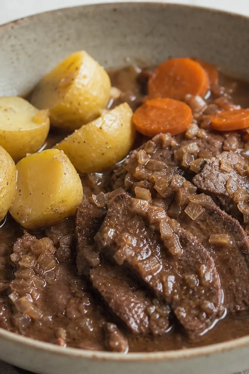 Tender Sauerbraten served with rich red wine gravy and boiled potatoes.