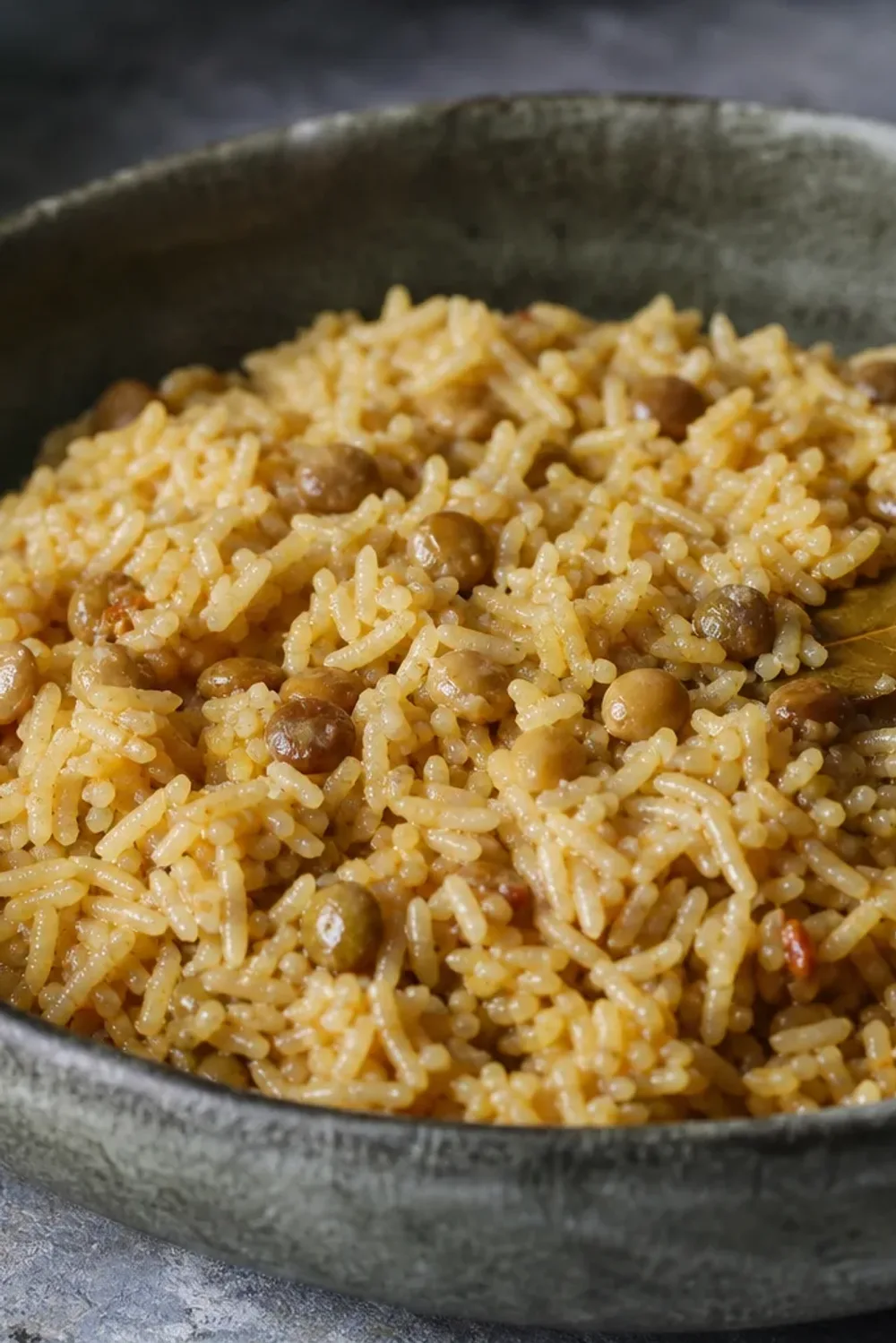 A vibrant plate of Arroz con Gandules, featuring fluffy rice, green pigeon peas, and colorful sofrito garnished with cilantro.