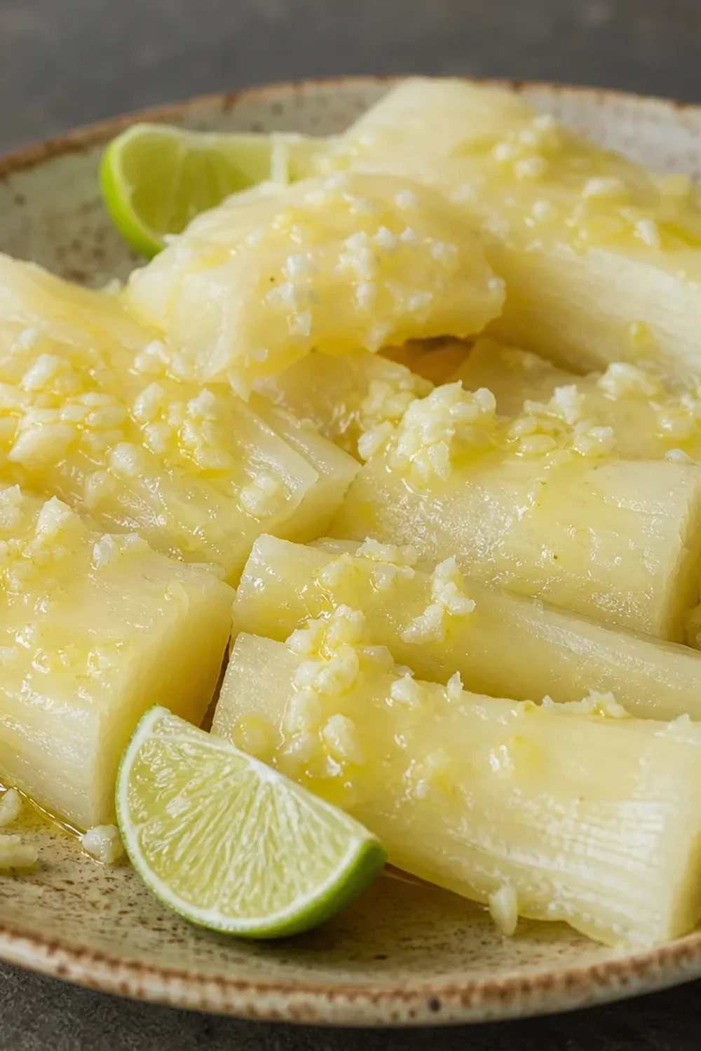 Boiled yuca served with a vibrant garlic citrus sauce and garnished with herbs.